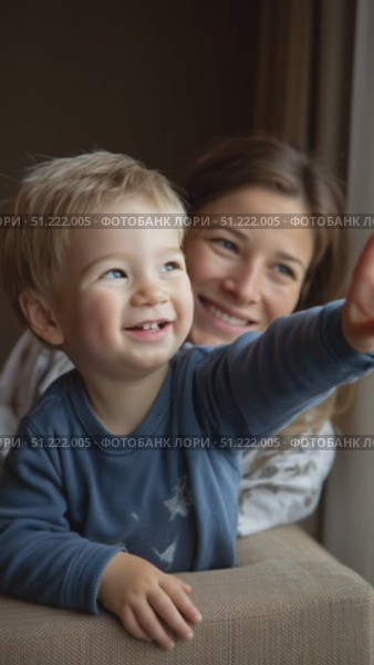 Infant boy eagerly pointing finger, mother gazing with tender smile, capturing intimate parent child connection and pure emotional warmth. Стоковое AI-видео, аниматор Юрий Поздников / Фотобанк Лори