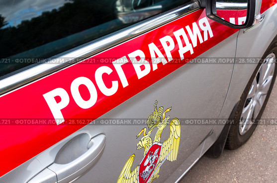 Inscription "Rosgvardia" and emblem of the troops of the National Guard of the Russian Federation on the board of car. Стоковое фото, фотограф FotograFF / Фотобанк Лори