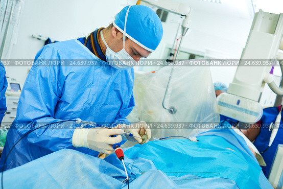 Interventional cardiology. Male surgeon doctor at operation. Стоковое фото, фотограф Дмитрий Калиновский / Фотобанк Лори