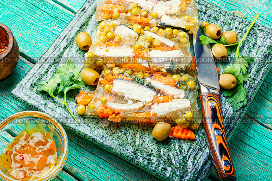 Jellied, cold dish of fish, filled with gelatinous broth.Russian food.Fish food.. Fish aspic on plate. Стоковое фото, агентство Ingram Publishing / Фотобанк Лори