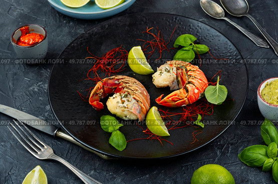 Juicy lobster tail with lime and saffron, luxurious seafood dish. Luxury seafood.. Preparing lobster tails. Стоковое фото, агентство Ingram Publishing / Фотобанк Лори