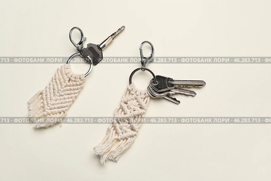 Keys with handmade cotton keychains on light background. Стоковое фото, фотограф Pixel_shot / Фотобанк Лори