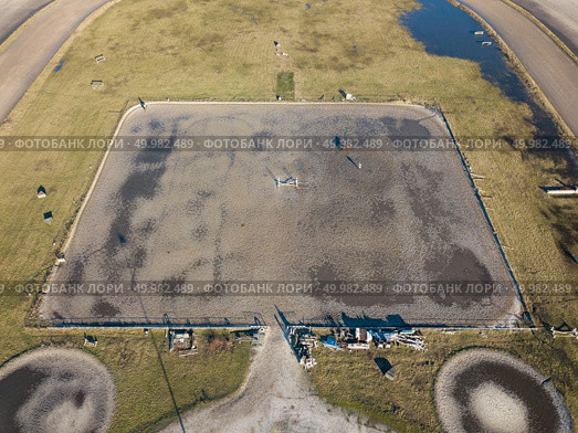 Kiev, Ukraine.- February 02,2018: Aerial view on a hippodrome with a horse, people and shadows. Photo taken with a drone. Kiev, Ukraine.- February 02,2018: Aerial view on a hippodrome with a horse, people and shadows. Редакционное фото, агентство Ingram Publishing / Фотобанк Лори