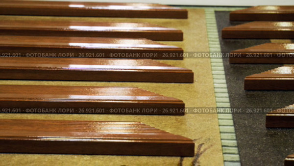 Lacquered furniture pieces of furniture are being loaded on a conveyor. 4K. Стоковое видео, видеограф ActionStore / Фотобанк Лори