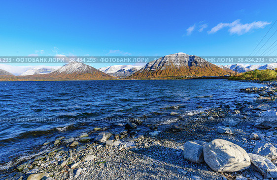 Landscape Big Vudyavr Lake  in the Hibiny mountains. The mountains are covered with snow. Стоковое фото, фотограф Михаил Аккуратoв / Фотобанк Лори