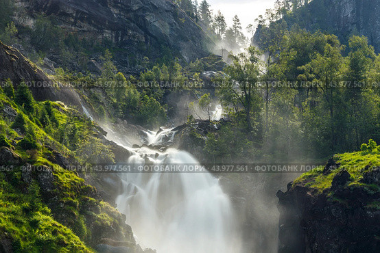 Latefossen is one of the most visited waterfalls in Norway and is located near Skare and Odda in the region Hordaland, Norway. Consists of two separate streams flowing down from the lake Lotevatnet. (2019 год). Стоковое фото, фотограф Андрей Армягов / Фотобанк Лори