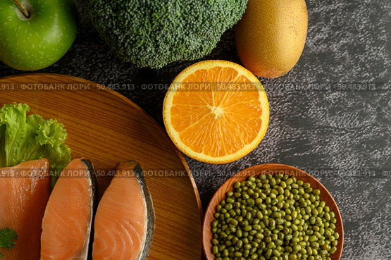 Legumes, fruit and salmon pieces on a wooden plate. Стоковое фото, агентство Ingram Publishing / Фотобанк Лори