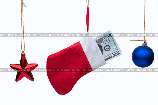 Lot of dollars in a Christmas sock and Christmas tree toys on a white background isolated. Стоковое фото, фотограф Ярославский Максим / Фотобанк Лори