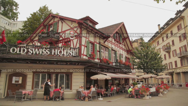 Lucerne, Switzerland. July 25, 2015. Old swiss house. People are resting. Люцерн, Швейцария. 25 июля 2015 года. Старый дом в Швейцарии. Люди отдыхают. Редакционное видео, видеограф Александр Артеев / Фотобанк Лори