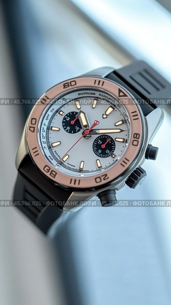 Luxury chronograph watch with rose gold bezel and black rubber strap. Стоковое AI-изображение, AI-художник Юрий Поздников / Фотобанк Лори