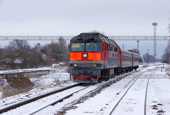 Магистральный тепловоз ТЭП70-0121 с пригородным поездом отправляется со станции Осташков, Тверская область (2021 год). Редакционное фото, фотограф Алексей Иванов / Фотобанк Лори