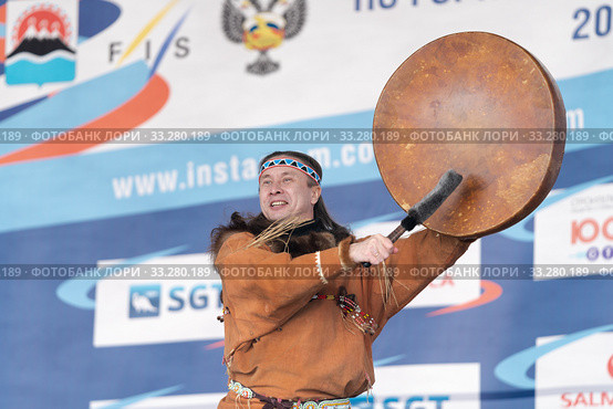 Male dancer in national clothes aboriginal people expression dancing with tambourine. Concert Koryak Dance Ensemble Mengo (2019 год). Редакционное фото, фотограф А. А. Пирагис / Фотобанк Лори