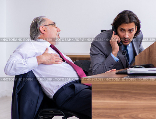 Male employee suffering from heart attack in the office. Стоковое фото, фотограф Elnur / Фотобанк Лори