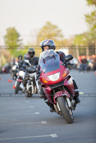 Male motorcyclist riding through cones on gymkhana skill training. Стоковое фото, фотограф Кекяляйнен Андрей / Фотобанк Лори