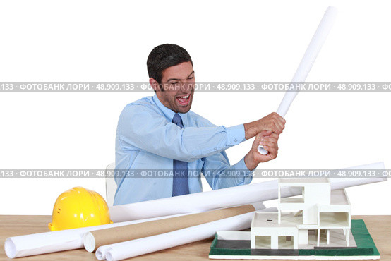 Man about to destroy a building model. Стоковое фото, агентство Ingram Publishing / Фотобанк Лори