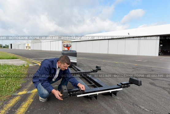 man checking machine for carrying luggage. Стоковое фото, агентство Ingram Publishing / Фотобанк Лори