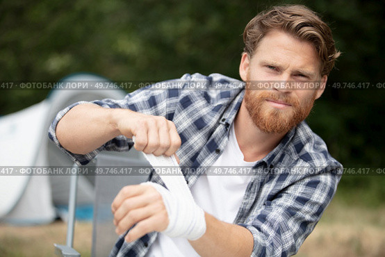 man finishes his bandaged hand. Стоковое фото, агентство Ingram Publishing / Фотобанк Лори