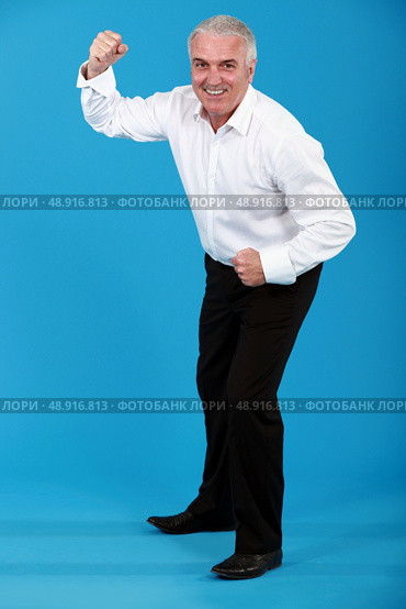 man in a suit dancing. Стоковое фото, агентство Ingram Publishing / Фотобанк Лори