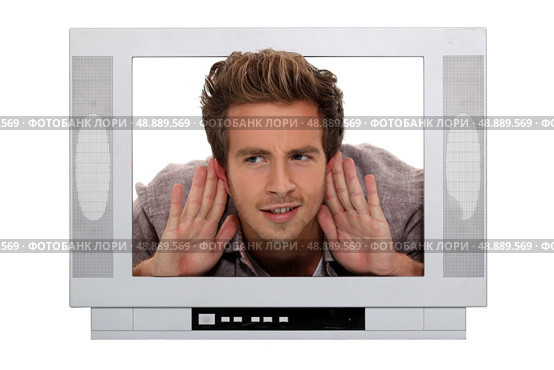 Man stuck in a television screen and struggling to hear. Стоковое фото, агентство Ingram Publishing / Фотобанк Лори