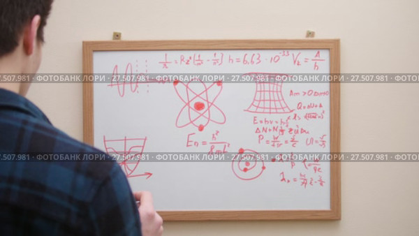 Man writing and drawing formulas, graphs and charts with marker on white board. Стоковое видео, видеограф Константин Шишкин / Фотобанк Лори