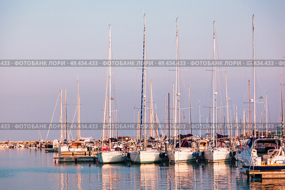 Marina with docked yachts at sunset in Giulianova, Italy. Marina with docked yachts at sunset. Стоковое фото, агентство Ingram Publishing / Фотобанк Лори