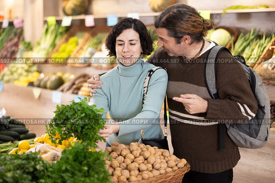 Married couple selects fresh parsley from supermarket counter. Стоковое фото, фотограф Яков Филимонов / Фотобанк Лори