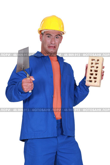 Mason holding a trowel. Стоковое фото, агентство Ingram Publishing / Фотобанк Лори