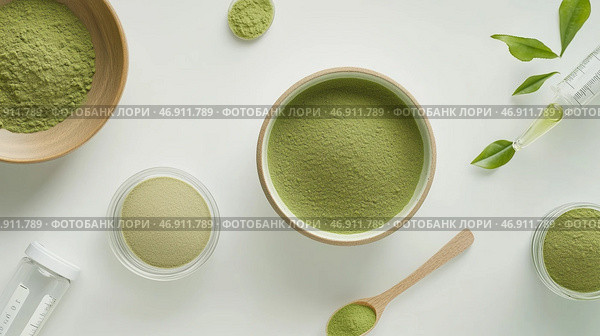 Matcha powder and green tea leaves displayed on white background with measuring tools and bowls. Стоковое AI-изображение, AI-художник Сергей Толмачёв / Фотобанк Лори