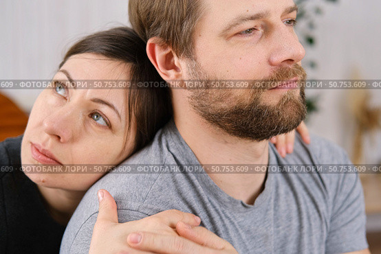 Mature couple hugging hugging each other kissing at home bedroom. Intimate Moment. Tender embrace shared between a loving middle age man and woman, husband and wife. Deep love. Low key, cinematic. Стоковое фото, фотограф Марина Демидюк / Фотобанк Лори