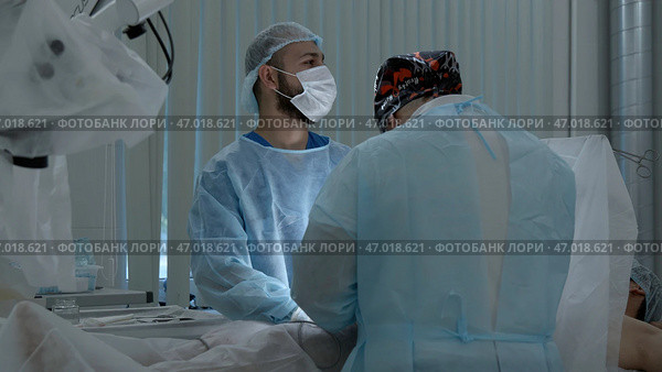 Medical workers performing surgery on a patient under anesthesia. Стоковое фото, фотограф David Kashakhi / Фотобанк Лори
