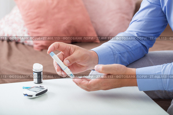 medicine, diabetes, glycemia, health care and people concept - close up of male finger with test stripe. Стоковое фото, фотограф Майя Крученкова / Фотобанк Лори