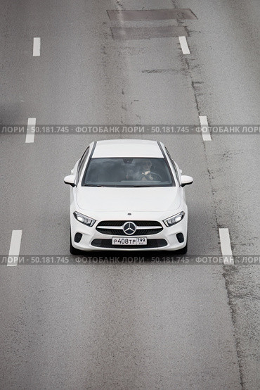 Mercedes-Benz A-Class (W177) driving on highway, above front view. White elegant luxury car sedan on speedway. Редакционное фото, фотограф Константин Григорьев / Фотобанк Лори