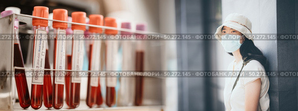 MERS-CoV Chinese infection Corona Virus masked girl on the background of COVID-19 blood test in medical laboratory. Стоковое фото, агентство Ingram Publishing / Фотобанк Лори