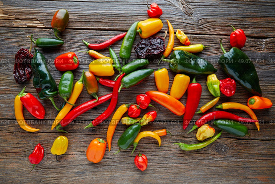 Mexican hot chili peppers colorful mix habanero poblano serrano jalapeno on wood. Стоковое фото, агентство Ingram Publishing / Фотобанк Лори