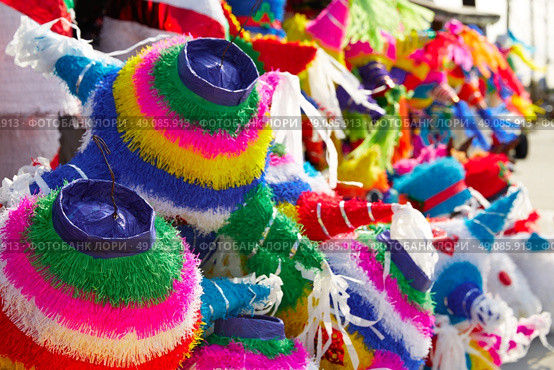 Mexican party pinatas decorated with fringed tissue colorful paper. Стоковое фото, агентство Ingram Publishing / Фотобанк Лори