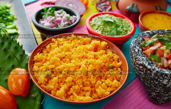 Mexican yellow rice with chilis and sauces in colorful background. Стоковое фото, агентство Ingram Publishing / Фотобанк Лори