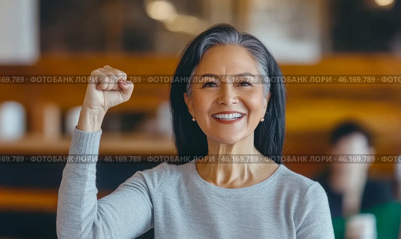 Middle aged hispanic woman with raised fist of empowerment, strength and women solidarity, International Womens Day concept. Стоковое AI-изображение, AI-художник Анастасия Золотницкая / Фотобанк Лори
