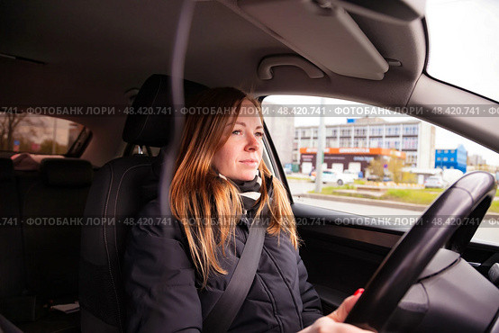 Mindful Journey of a Woman Driving Through a Vibrant Urban Landscape on a Sunny Day. Стоковое фото, фотограф Aleksandr Golubev / Фотобанк Лори