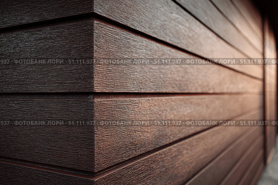 Modern brown wood plank texture. Fiber cement siding. Exterior of composite wall. Plastic material is eco-friendly polymer panels in rows. Wooden grain surface. Hollow WPC boards. Dark oak color. PE. Стоковое AI-изображение, AI-художник Марина Демидюк / Фотобанк Лори