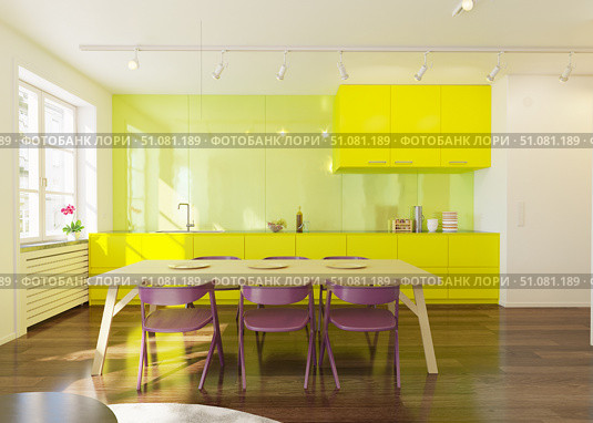 Modern kitchen and dining area with bright yellow cabinets, wooden table, and purple chairs. Contemporary home interior for real estate. Стоковое фото, фотограф Виктор Застольский / Фотобанк Лори