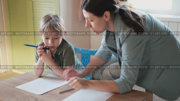 Mom education son writing. Kids learn and study in home school. Mommy female helping teaching little boy support studying, learning homework. Child care teach study. Knowledge day. Children schooling. Стоковое видео, видеограф Марина Демидюк / Фотобанк Лори