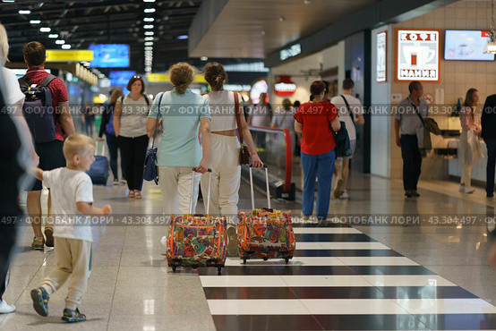 Moscow, Russia - August 17, 2022: Modern Sheremetyevo International Airport at summer day. Airport inside image, departure waiting area. Moving walkway. Comfortable way. Travelling concept. Редакционное фото, фотограф YuryKara / Фотобанк Лори