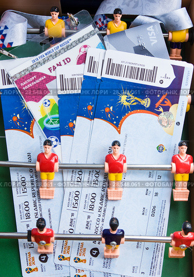 Moscow, Russia - June 8, 2018: Preparing to enter matches of confederations Cup in 2017 and World Cup 2018 in Russia. Fan set - tickets, credit card Visa and id-card on toy football. Редакционное фото, фотограф Papoyan Irina / Фотобанк Лори