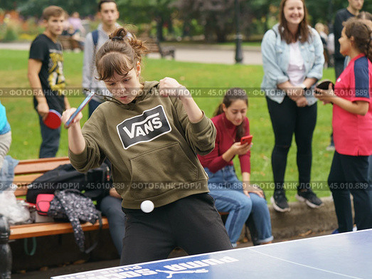 Moscow, Russia - September 5, 2019: Photography of sports competitions in the Gorky park. Young woman playing ping-pong in summer day.  Healthy lifestyles of youth. Редакционное фото, фотограф YuryKara / Фотобанк Лори