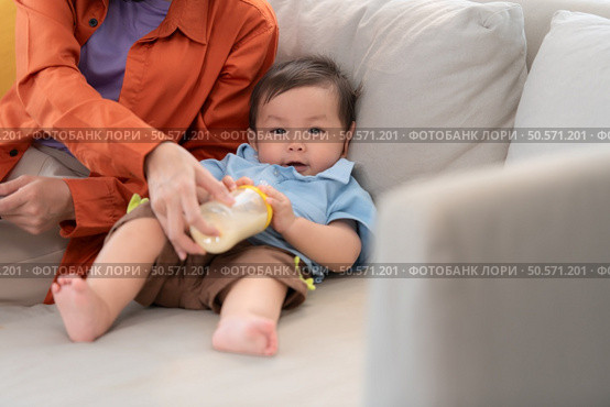 Mother and son play together after dad comes home from work. Стоковое фото, агентство Ingram Publishing / Фотобанк Лори
