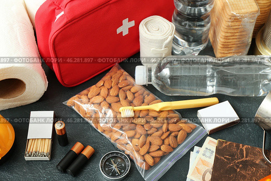 Necessities for emergency bag on dark table, closeup. Стоковое фото, фотограф Pixel_shot / Фотобанк Лори