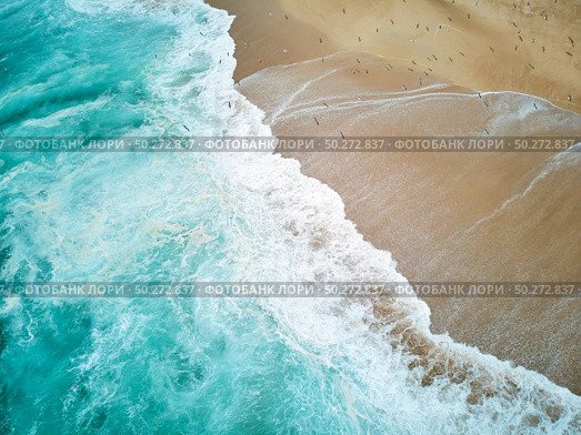 North Beach in Nazare Portugal with foaming waves and flying seagulls. Стоковое фото, агентство Ingram Publishing / Фотобанк Лори