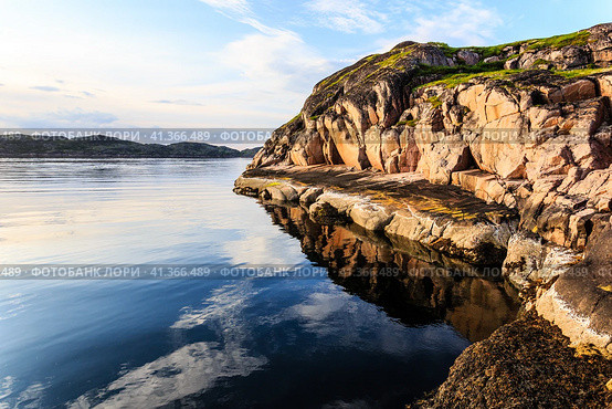 Northern polar summer. Beautiful coastline of Barents sea, rocks reflecting in the calm water surface. Arctic ocean, Kola Peninsula, Russia. Стоковое фото, фотограф VittoriaChe / Фотобанк Лори