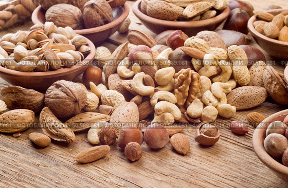 Nuts mix, with almond, cashews, pistachios, hazelnuts on wood background. Стоковое фото, агентство Ingram Publishing / Фотобанк Лори