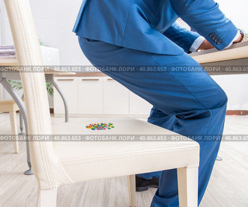 Office prank with sharp thumbtacks on chair. Стоковое фото, фотограф Elnur / Фотобанк Лори